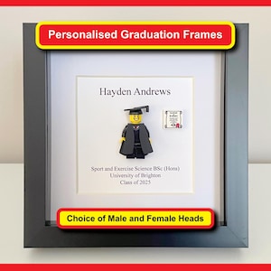 May include: A black shadow box frame containing a white mount with the printed text Hayden Andrews, Sport and Exercise Science BSc (Hons), University of Brighton, Class of 2025. A plastic minifigure wearing a graduation cap and gown is centred.