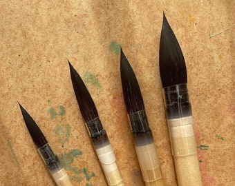 May include: Four Roubloff brand paint brushes with black bristles and wooden handles. The brushes are labeled with their sizes: 4, 6, 8, and 10.