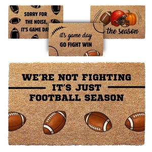 May include: Four rectangular tan coir doormats featuring football-themed graphics and text. The mats display phrases including 'SORRY FOR THE NOISE, IT'S GAME DAY', 'it's game day GO FIGHT WIN', 'the season', and 'WE'RE NOT FIGHTING IT'S JUST FOOTBALL SEASON'.