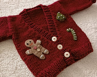 christmas cardigan with cookie man motif for sale, crocheted burgundy cardigan for children, hand knit christmas cardigan for baby