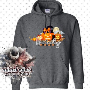 May include: A gray hooded sweatshirt with a graphic design of pumpkins, a black cat, and the text "Kentucky Halloween".