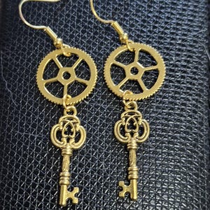 Steampunk gold tone key and gears dangle earrings