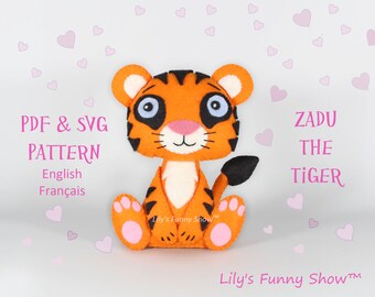 May include: A felt tiger plush toy pattern, with the text "ZADU THE TIGER" and "Lily's Funny Show™" on the image. The pattern is available in PDF and SVG formats.