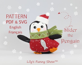 May include: A felt penguin wearing a red and white Santa hat, a green scarf, and a red dress with white polka dots. The penguin is holding a white fish in its right flipper. The text "Slider the Penguin" is written in red cursive lettering. The text "Lily's Funny Show™" is written in red lettering at the bottom of the image.