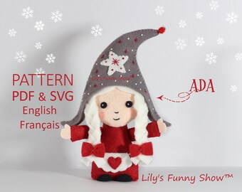 May include: A handmade felt doll named Ada, wearing a red dress and a gray hat with a star design. The doll has white braided hair and a white apron with a heart. The image includes text that says "PATTERN PDF & SVG English Français".