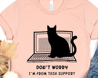 May include: A pink t-shirt with a black cat sitting on a laptop. The text on the shirt reads "Don't worry I'm from tech support."