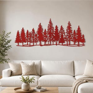 May include: A large, horizontal wall art piece featuring a detailed, laser-cut silhouette of a dense forest of pine trees. The entire structure is finished in a solid, vibrant red colour, showcasing intricate branch patterns and a continuous base line.