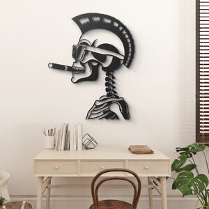 May include: Black and white metal wall art of a skull with a mohawk, sunglasses, and a cigarette. The skull is in profile and has a skeleton body.