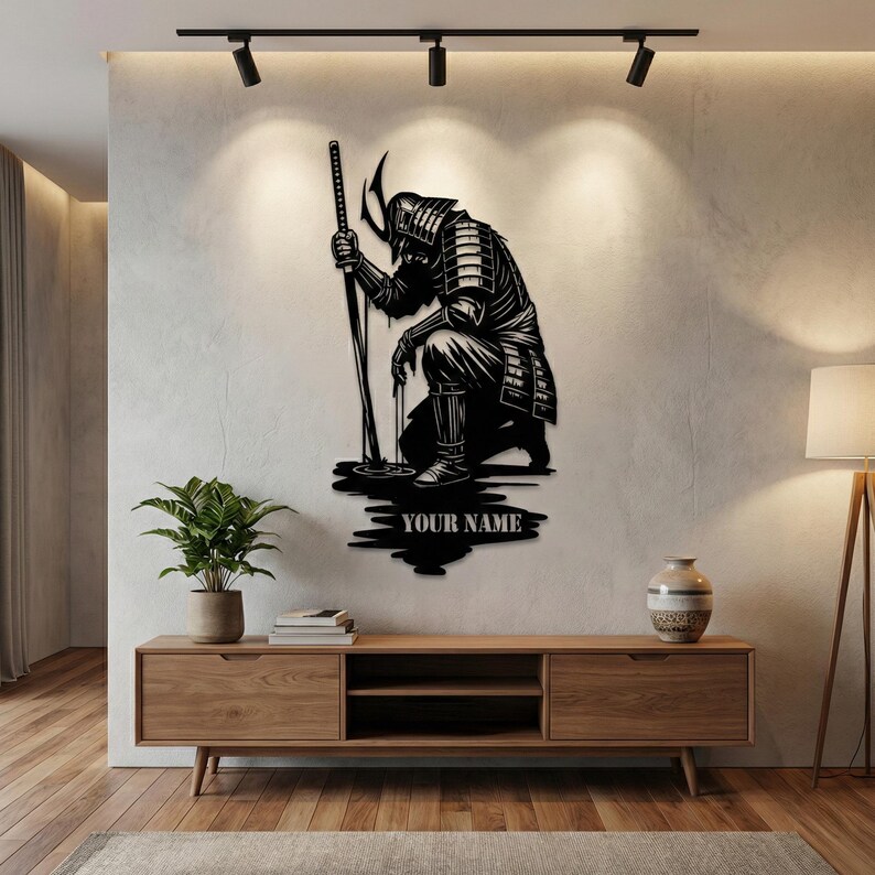 May include: Black metal wall art depicting a kneeling samurai warrior holding a katana. The artwork features intricate details of the samurai's armor and helmet. The text "YOUR NAME" is below the samurai.