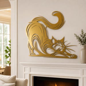 Può includere: Un oggetto da parete in metallo color oro a forma di gatto che si stira. Il design presenta linee ritagliate che definiscono la schiena arcuata, la lunga coda e le zampe anteriori estese del felino, creando un effetto silhouette sulla parete.