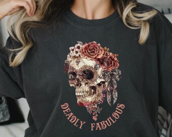 May include: A black t-shirt with a skull wearing a floral crown. The skull is surrounded by the text "Deadly Fabulous".