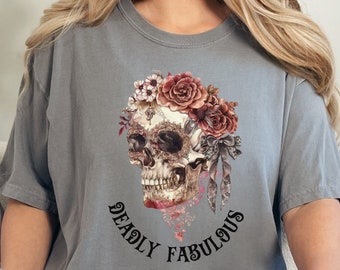 May include: Gray t-shirt with a floral skull graphic and the text "Deadly Fabulous".
