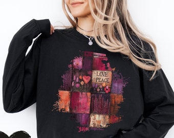 May include: Black long-sleeve sweatshirt with a colorful patchwork design featuring the words "Love Peace" in a white rectangle.