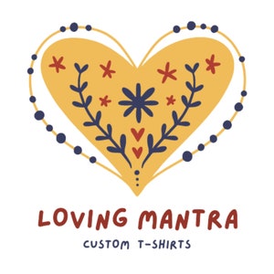 May include: A yellow heart with a floral design and a blue beaded border. The text "LOVING MANTRA CUSTOM T-SHIRTS" is below the heart.