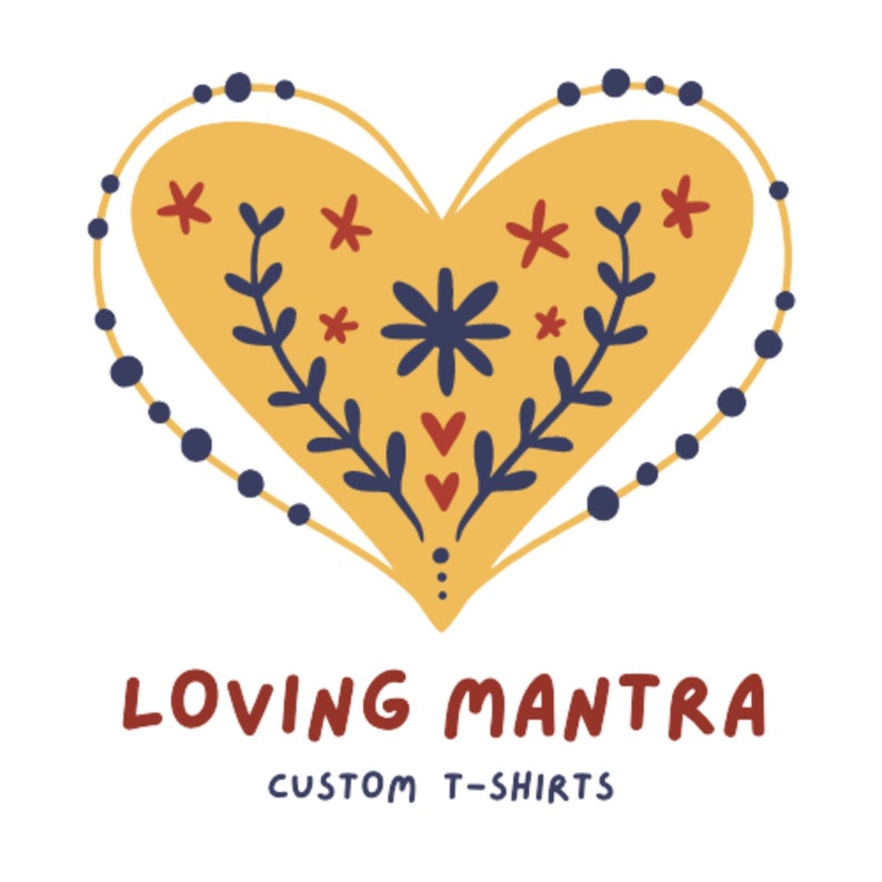 May include: A yellow heart with a floral design and a blue beaded border. The text "LOVING MANTRA CUSTOM T-SHIRTS" is below the heart.
