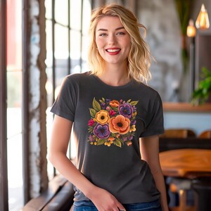 May include: A dark gray t-shirt with a floral print featuring orange, yellow, purple, and green flowers.
