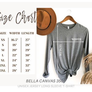 May include: A gray long-sleeve Bella Canvas 3501 unisex jersey t-shirt displayed on a wooden hanger. The image includes a size chart with measurements in inches for width and length, ranging from XS to 3XL.