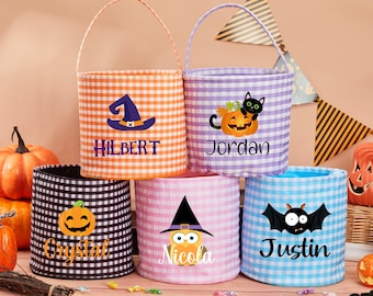 May include: Five Halloween trick-or-treat bags with gingham patterns in orange, purple, pink, black, and blue. Each bag has a different Halloween character and a name: Hilbert, Jordan, Nicola, Crystal, and Justin.