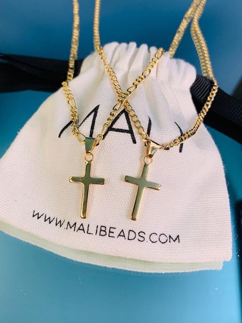 Our latest addition to our Cross Necklaces! Flaunt your faith or gift the perfect protection cross necklace. A dainty gold filled Chain adorned with a thick cross. Your item will be beautifully packaged ready for gifting.