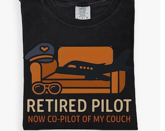 May include: Black t-shirt with a graphic of a pilot's hat, glasses, and a plane on an orange couch. The text reads "Retired Pilot Now Co-Pilot of My Couch."