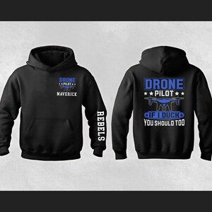 May include: Black hoodie with blue text that reads "DRONE PILOT" and "MAVERICK" on the front. The back of the hoodie has a drone graphic and the text "IF I DUCK YOU SHOULD TOO". The word "REBELS" is printed on the sleeve.
