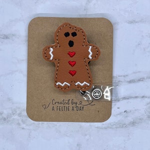 Bitten gingerbread man interchangeable badge reel feltie topper