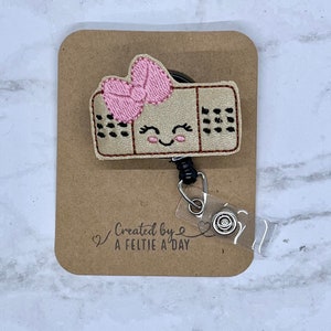 Bandage interchangeable badge reel feltie topper
