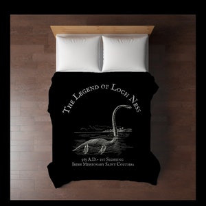 May include: Black and white illustration of the Loch Ness Monster on a black duvet cover. The text "The Legend of Loch Ness" is in a circle around the monster. The text "565 A.D. - 1st Sighting Irish Missionary Saint Columba" is below the monster.