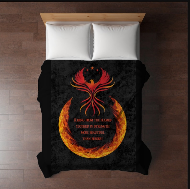 May include: Black and red phoenix rising from flames with the text "Rising from the flames, clothed in strength, more beautiful than before!"
