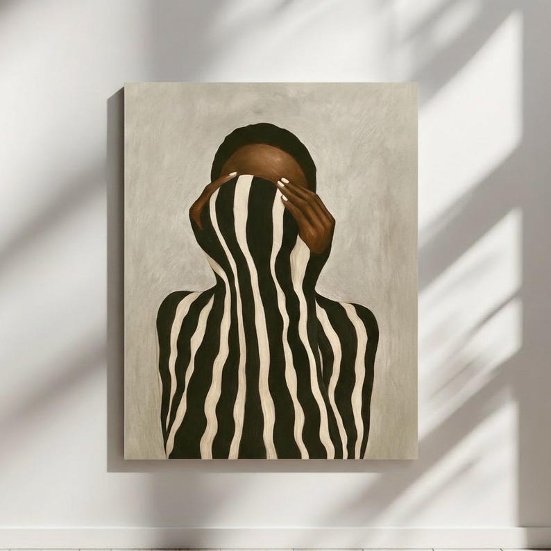 Modern abstract Black woman wall decor print with soft beige background and striking striped form.
