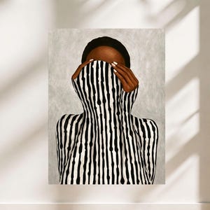 Op de afbeelding: Een artistiek portret van een persoon met een donkere huid, gekleed in een zwart-wit gestreept kledingstuk dat het gezicht bedekt. De handen, met verzorgde nagels, zijn zichtbaar. De achtergrond is lichtgrijs.