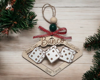 May include: Wooden Christmas bauble shaped like a diamond with three dice in the centre. The bauble is decorated with the words "Bounco", "Good Times", "Good Laughs", and "Great Friends".