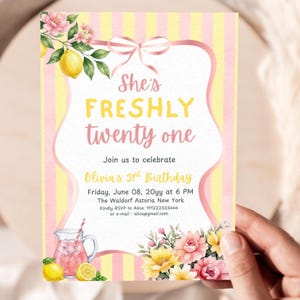 May include: A birthday invitation card featuring a yellow and white striped background with pink ribbon accents. The text reads She's FRESHLY twenty one, Join us to celebrate Olivia's 21st Birthday, Friday, June 08, 20yy at 6 PM, The Waldorf Astoria New York.