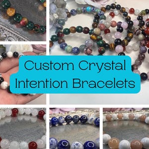 May include: A collection of custom crystal intention bracelets. The bracelets feature various colors and types of gemstones, including red, white, blue, and green beads. The text "Custom Crystal Intention Bracelets" is displayed in a blue box.