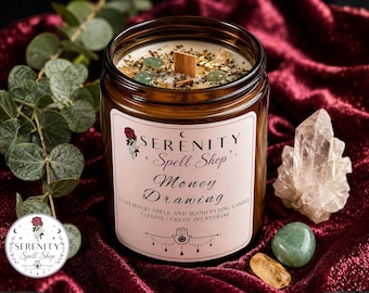 May include: A 212g amber glass jar candle with a wooden wick, topped with green aventurine stones and herbs. The label reads Serenity Spell Shop Money Drawing 212g Money Spell and Manifesting Candle Citrine | Green Aventurine with a hamsa icon.