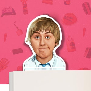 May include: A sticker featuring a cartoon illustration of a person with light brown hair, wearing a white shirt and blue tie. The background is pink with various red illustrations. The sticker is placed on top of a stack of white paper.