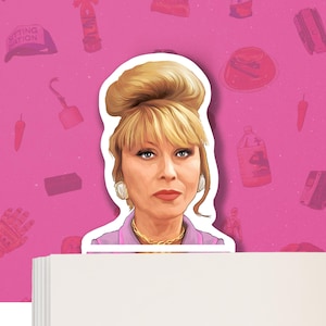 May include: A sticker of a woman with blonde hair styled in a bouffant, wearing a pink blouse and a gold necklace. The sticker is on a pink background with various other stickers.