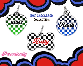 May include: Three dog tag pendants with a checkered pattern in black and white. The pendants are shaped like a heart, a circle, and a bone. The names "Vader", "Hank", and "Rusty" are written in a retro font on each pendant.