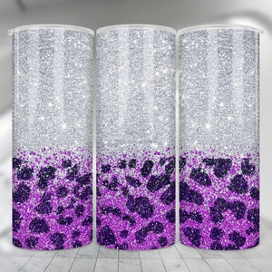 May include: Three silver glitter tumblers with a purple leopard print design. The tumblers are all the same size and shape.