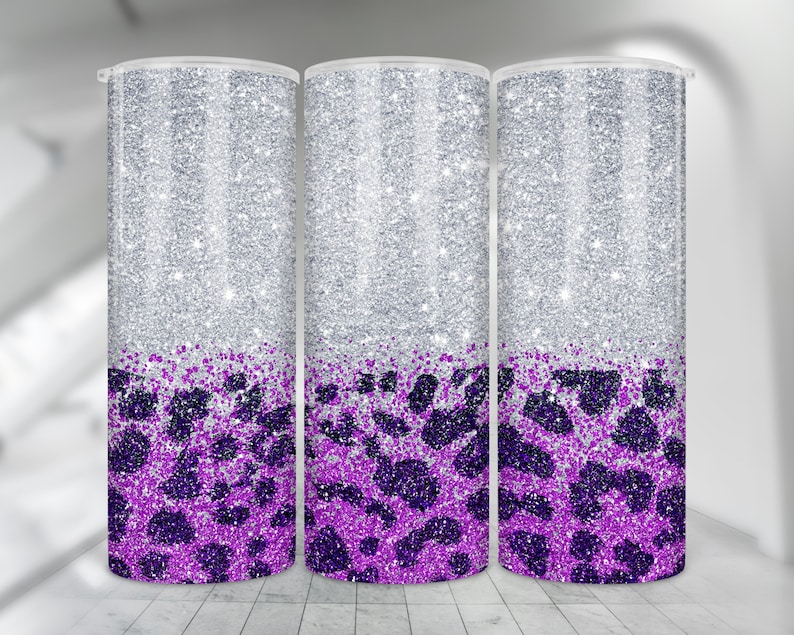 May include: Three silver glitter tumblers with a purple leopard print design. The tumblers are all the same size and shape.