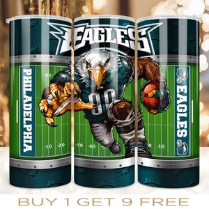 May include: Three stainless steel tumblers with a green and white football field design. The tumblers feature a cartoon image of a football player wearing a green and white uniform with the words "EAGLES" and "PHILADELPHIA" on the side.