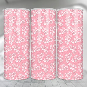 May include: Three pink tumblers with a white floral pattern. The tumblers are made of stainless steel and have a double-wall construction to keep drinks cold or hot.