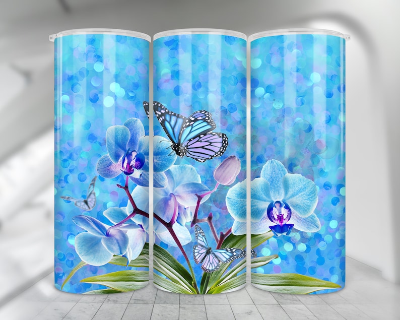 May include: A set of three blue and white tumbler cups with a design of blue orchids and butterflies on a blue glitter background.
