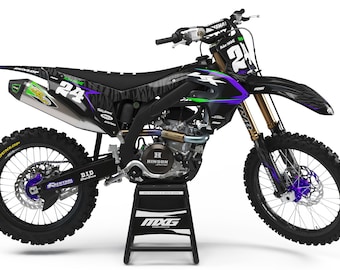May include: A black and purple motocross bike with a zebra print design. The bike has a green and black number plate with the number 24 on it. The bike is on a black stand with the word MXG on it.