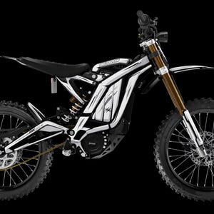 Puede incluir: Una moto de cross eléctrica en blanco y negro con detalles dorados. La moto tiene un asiento, neumáticos y manillar negros. Las horquillas delanteras son doradas y el cuadro es blanco con detalles negros. El fondo es negro.