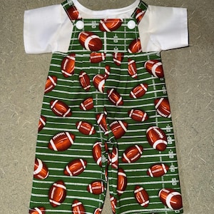 May include: A set of three ceramic mugs with a speckled, cream-colored glaze. Each mug features a different hand-painted floral design in shades of blue, green, and yellow. The mugs have a simple, rounded shape and a comfortable handle.