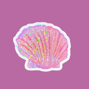 May include: A pink seashell with iridescent glitter accents. The shell is closed and has a white outline.
