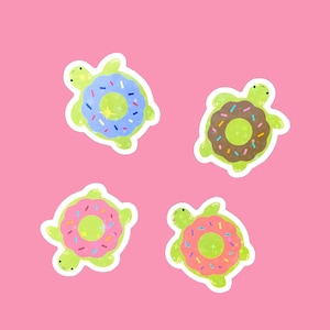 May include: Four green turtle stickers with donut-shaped shells. The donuts are decorated with colorful sprinkles and have different colored glazes: blue, brown, pink, and pink.