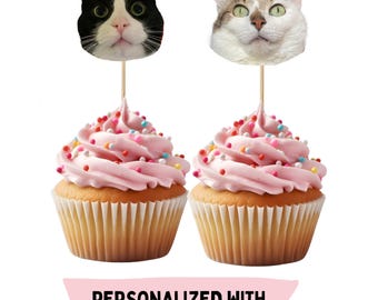 May include: Two cupcakes with pink frosting and colorful sprinkles, topped with cat face toppers wearing party hats. The text "PERSONALIZED WITH YOUR PET'S FACE!" is displayed on a pink banner below the cupcakes.