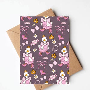 May include: A greeting card with a repeating pattern of cartoon geese wearing pink dresses, boots, and crowns. The design includes bows, candies, flowers, and necklaces on a dark purple background. The card is inside a brown envelope.